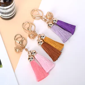 Detail showing multi-colored silk tassel keychains with elegant hollow golden bells.