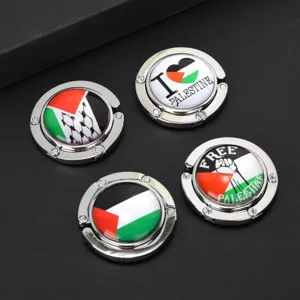 Detail view of foldable purse hooks with Palestinian flag and Free Palestine designs