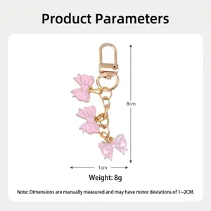 Close-up detail of a pink bow keychain with 8cm height and 8g weight specifications