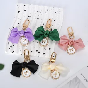 Elegant satin bowknot keychains with pearl and diamond pendants in five vibrant colors
