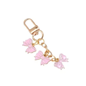 Elegant pink enamel triple bowknot keychain with golden lobster clasp and chain for bags