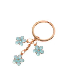 Rose gold metal keychain with three light blue enamel cherry blossom flower charms
