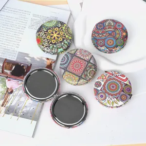 Macro detail of Bohemian style folding pocket mirrors with colorful mandala patterns