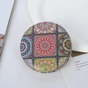 Detailed view of bohemian mandala pattern on vintage round folding pocket mirror