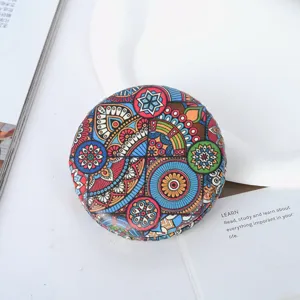 Detailed view of the vibrant Bohemian pattern on a round PU leather pocket mirror