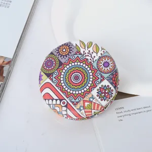 Detail view showing the vibrant bohemian pattern on this round PU leather folding mirror