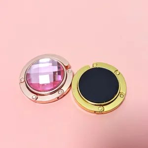 Macro detail showing the pink gemstone inlay and black non-slip back of these bag hooks.