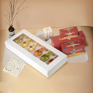 Collection of colorful Aladdin lamps presented in a white window box and red gift boxes
