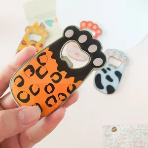 Detailed view of a cute leopard print cat paw shaped bottle opener and fridge magnet.