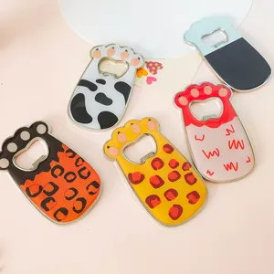 Close-up of colorful cat paw shaped fridge magnets with various animal patterns.