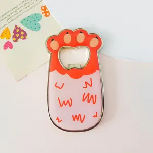 Detail view of cute cat paw shaped metal fridge magnet bottle opener with resin finish.