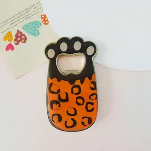 Close-up detail of a cute cat paw shaped magnetic bottle opener with leopard pattern