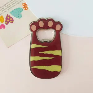 Detailed view of the cute cat paw metal fridge magnet with a smooth enamel finish.