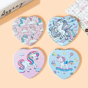 Detail of four heart-shaped folding pocket mirrors with cartoon unicorn designs
