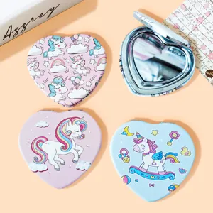Detail view of heart-shaped compact mirrors with cute unicorn patterns