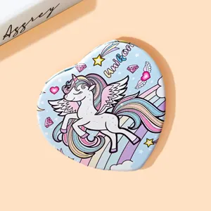 Detailed view of heart-shaped folding mirror with cute cartoon unicorn and rainbow