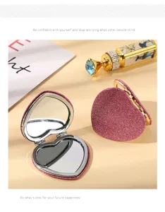 Close-up of heart-shaped glitter compact mirror with double-sided glass