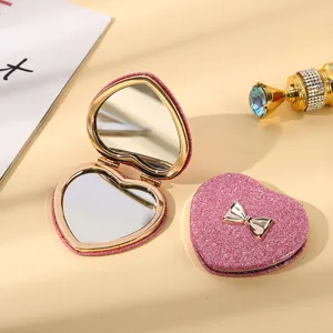 Pink heart-shaped glitter folding pocket makeup mirror with silver bow decoration