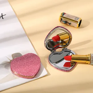 Mini heart-shaped folding compact mirror with pink glitter finish for portable use