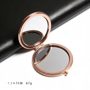 Close-up detail of a portable rose gold double-sided folding round pocket makeup mirror