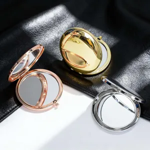 Close-up of portable double-sided compact mirrors in rose gold, gold, and silver