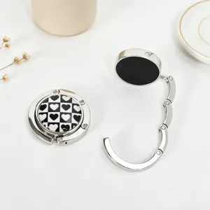 Portable foldable metal bag hook for desk featuring a stylish heart checkerboard pattern