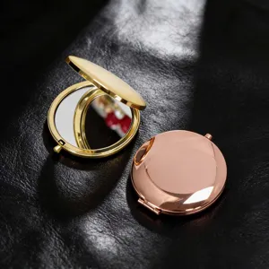 Detailed view of portable compact makeup mirrors in gold and rose gold finishes