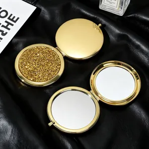 Detailed macro view of golden diamond glitter folding pocket mirror with double-sided mirrors