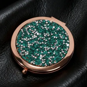 Close-up of glitter and stud detail on rose gold round folding makeup mirror
