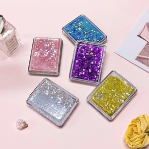 Detail of portable quicksand folding mirrors with heart-shaped glitter sequins.