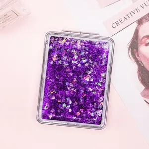Purple heart quicksand makeup mirror with sparkling glitter detail close-up view