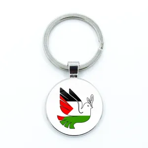 Detailed view of Palestine flag peace dove keychain pendant with olive branch design