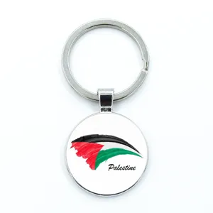 Detailed macro view of a circular metal keychain featuring the Palestinian flag design.