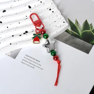 Detailansicht eines festlichen Weihnachts-Schlüsselanhängers mit Stern- und Glockenanhänger.