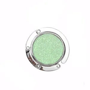 Portable foldable round handbag hook for tables with sparkling light green glitter inlay