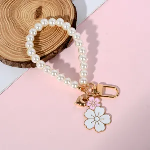 Elegant pearl bead phone strap detail with white and pink enamel flower charms