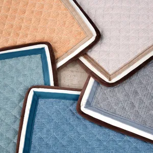 Close-up view of the quilted textured fabric and neat edging detail of the soft office chair cushion.