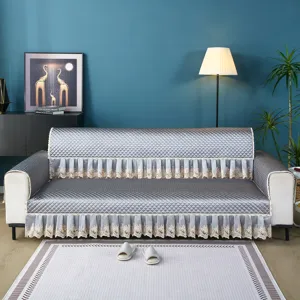 Quilted sofa cover with elegant lace fringe, thick protective slipcover for living room.
