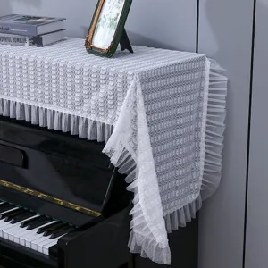 Housse anti-poussière pour piano en dentelle blanche, protection élégante et moderne.