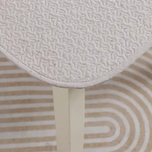 Close-up detail of textured chair cushion showing fine stitching, edge binding, and clean fabric.