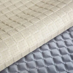 Quilted sofa cushion fabric detail showing thick padding, rhombus pattern and anti-slip dots.