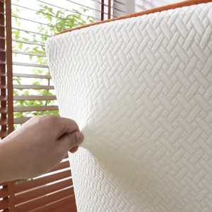 Close-up detail of textured stretch chair cover fabric, showing high elasticity and woven pattern.