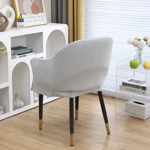 Detailed view of the light gray woven chair cover showing back texture and fit in a cozy room setting.