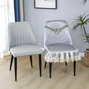 Detailed view of luxury quilted dining chair cover with lace trim, elegant home decor style.
