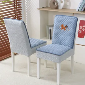 Blue quilted dining chair cover detail, thickened stretchy fabric with horse embroidery.