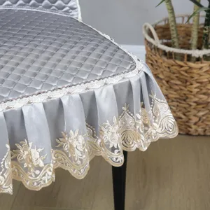 Grey quilted dining chair cover with delicate lace trim and embroidered ruffles detail.