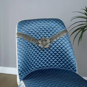 Blue quilted dining chair cover with elegant gold lace flower embroidery for home decor.