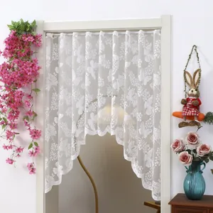 White lace door curtain with delicate floral butterfly pattern hanging in bedroom doorway decor.