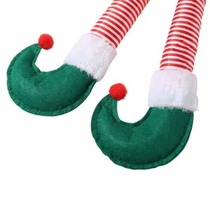 Gambe decorative per elfo di Natale con strisce rosse e bianche e stivali in feltro verde.