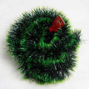Detail view of dark and lime green Christmas tinsel garland with soft textured needles.
